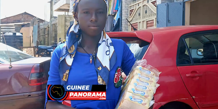 Fanta CONDÉ, élève, tenant des marchandises qu’elle revend en période de vacances/Lansanaya-Takoui, vendredi, 23 août 2024 - Photo : Aly Pires CAMARA - guineepanorama.com