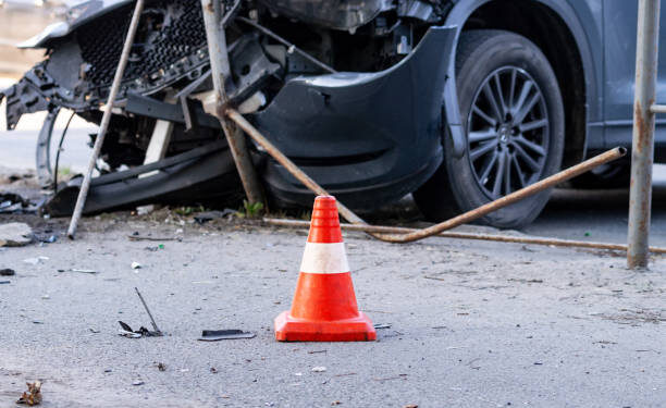 road cone against the background of a car broken in a road accident. Selective focus