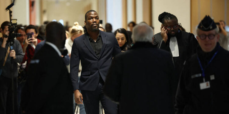 Mathias Pogba (C), who is accused of pressurising his brother French football player Paul Pogba and his family, arrives at the Paris Criminal Court for his trial, in Paris on November 26, 2024. Six men included Pogba's own brother Mathias, go on trial in Paris accused of blackmail, attempted extortion of millions of euros and holding the Juventus and France football player Paul Pogba at gunpoint in 2022. (Photo by Anne-Christine POUJOULAT / AFP)